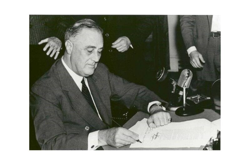 President Franklin D. Roosevelt signing the Federal Credit Union Act of 1934 (on June 26, 1934).